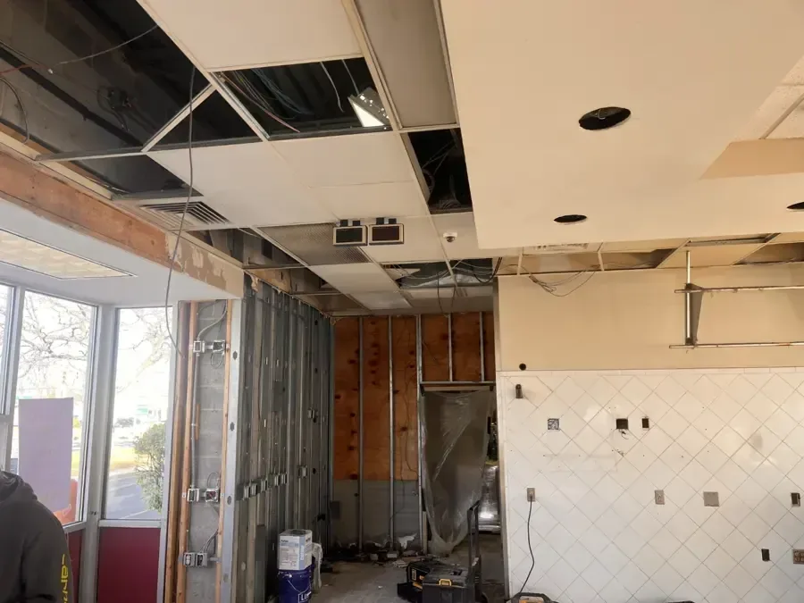 Kitchen with the ceiling and walls opened to the framing during a water loss