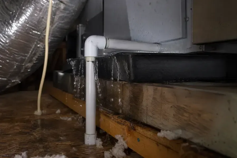 Water overflowing an AC drain pan and condensate line in an attic air handler