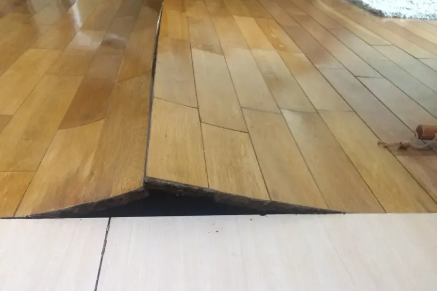Hardwood floor boards buckled upward after soaking up water