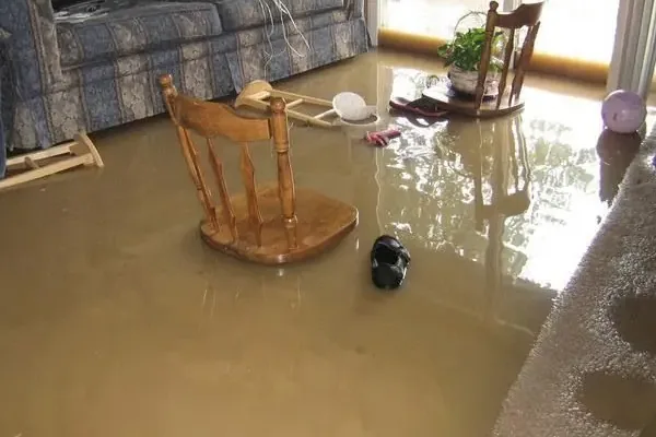 Muddy storm water filling a living room