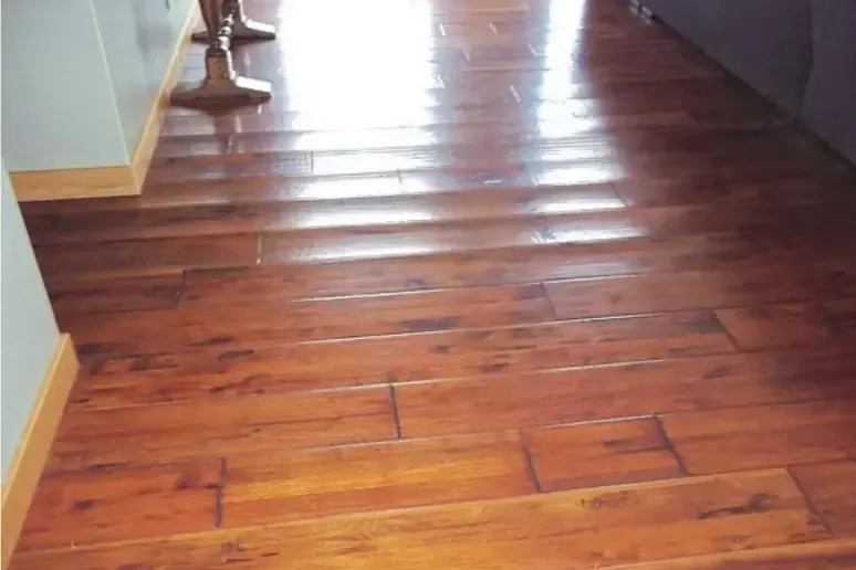 Standing water across a hardwood hallway before extraction